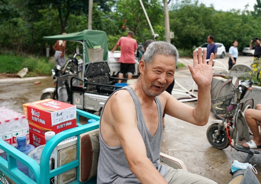 8月5日，從安置點回來的北京市房山區(qū)青龍湖鎮(zhèn)口頭村村民高大爺領到生活物資準備回家。新華社記者 張晨霖 攝