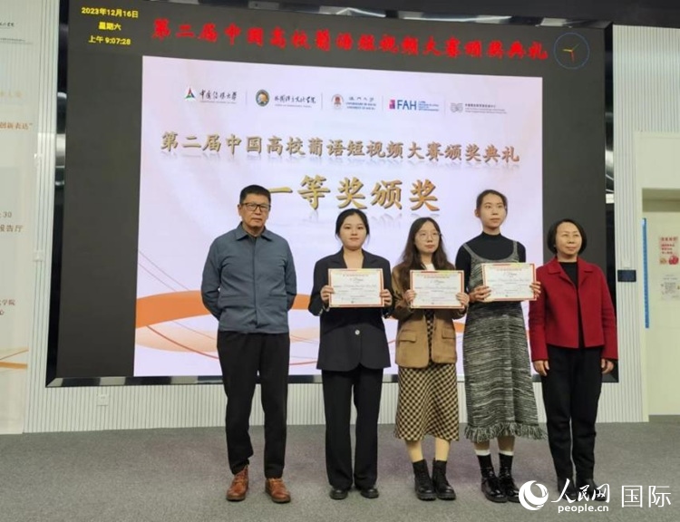 澳門大學中葡雙語教學暨培訓中心主任姚京明（左一）和中國傳媒大學外國語言文化學院院長文春英（右一）為一等獎獲得者頒獎。人民網(wǎng)記者 魯揚攝