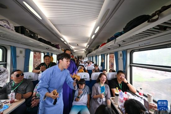 9月7日，相聲演員在S910列車上為旅客表演快板。